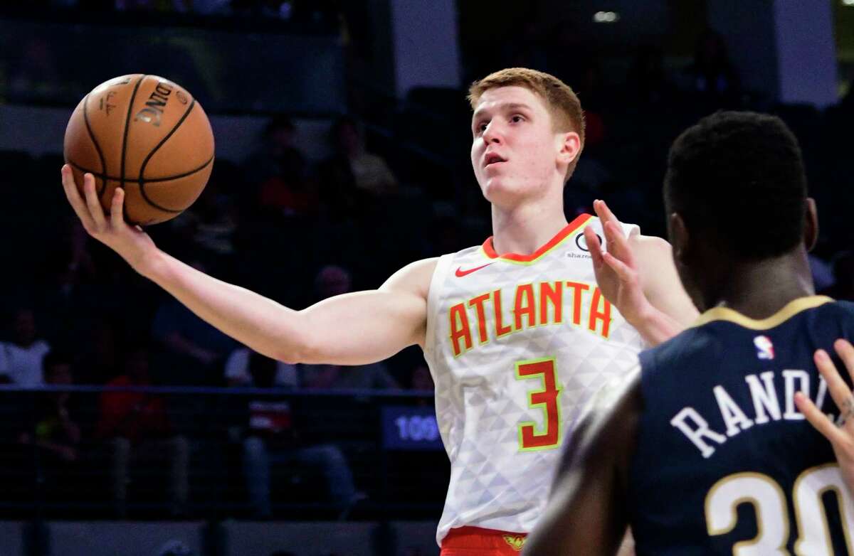 FILE - In this Oct. 1, 2018 file photo, Atlanta Hawks rookie guard Kevin Huerter (3) goes to the basket past the defense of New Orleans Pelicans forward Julius Randle during the second half of a preseason basketball game in Atlanta. Wearable technology has been around the NBA for the past several seasons. It's not permitted on game nights, and anything specific about processes the 30 teams are using falls into the category of closely guarded secret. Huerter said in his short time as a pro, he's learned a ton about his body that he didn't even know because of what he's gleaned off what his team has collected. (AP Photo/John Amis, File)