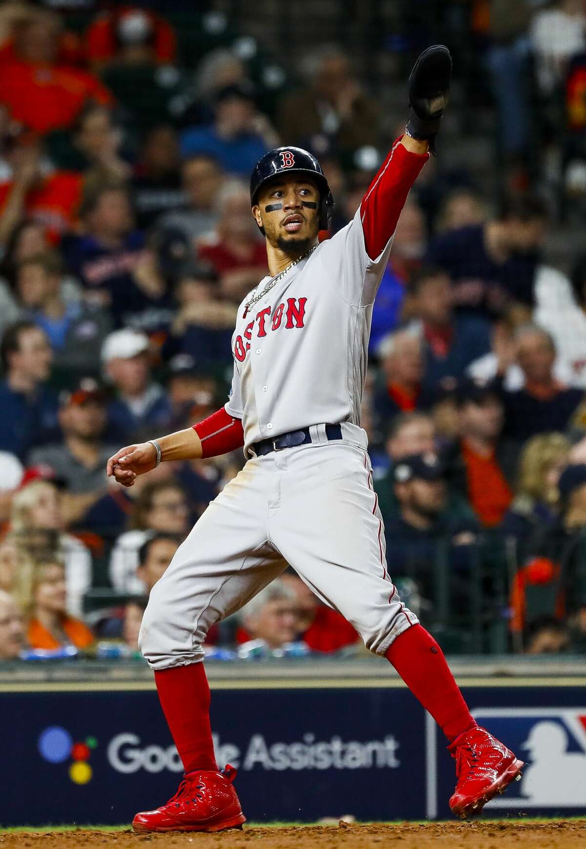 Boston Red Sox Mookie Betts (50) crosses home plate after an RBI single by Boston Red Sox J.D. Martinez (28) during the eighth inning of Game 4 of the American League Championship Series at Minute Maid Park on Wednesday, Oct. 17, 2018, in Houston.