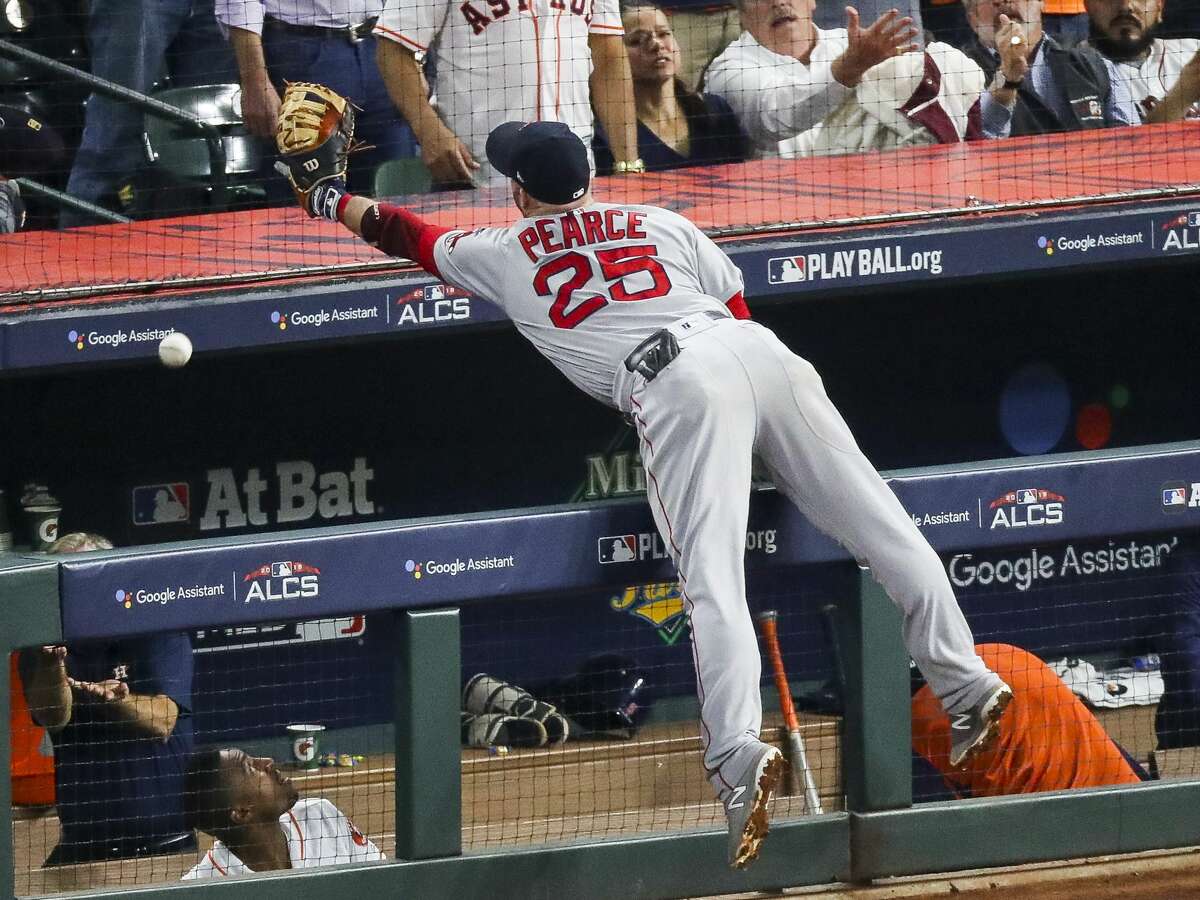 Boston Red Sox Steve Pearce (25) cannot reach a foul ball in the Astros dugout during the seventh inning of Game 4 of the American League Championship Series at Minute Maid Park on Wednesday, Oct. 17, 2018, in Houston.