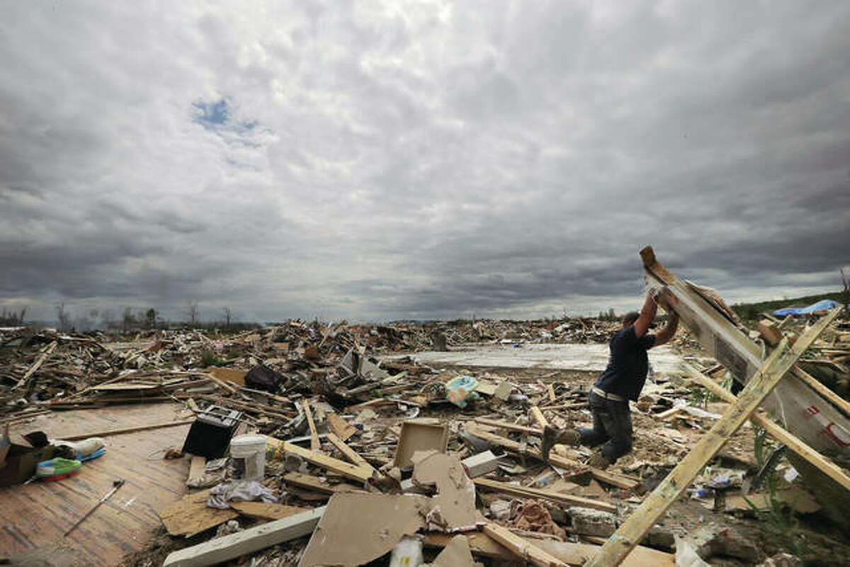 Dustin Shaw lifts debris as he searches through what is left of his sister’s house at Parkwood Meadows neighborhood after a tornado in Vilonia, Arkansas, in 2014. A new study finds that tornado activity is generally shifting eastward to areas just east of the Mississippi River that are more vulnerable such as Mississippi, Arkansas and Tennessee. And it’s going down in Oklahoma, Kansas and Texas.
