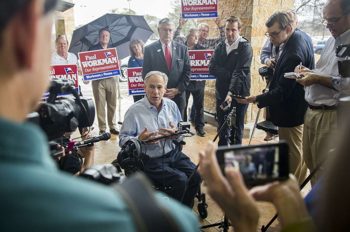Gov. Greg Abbott and Rep. Paul Workman answers questions from the local News Media after they made their way to Randalls supermarket to cast their early voting ballot on Tuesday, Feb. 20, 2018. RICARDO B. BRAZZIELL / AMERICAN-STATESMAN