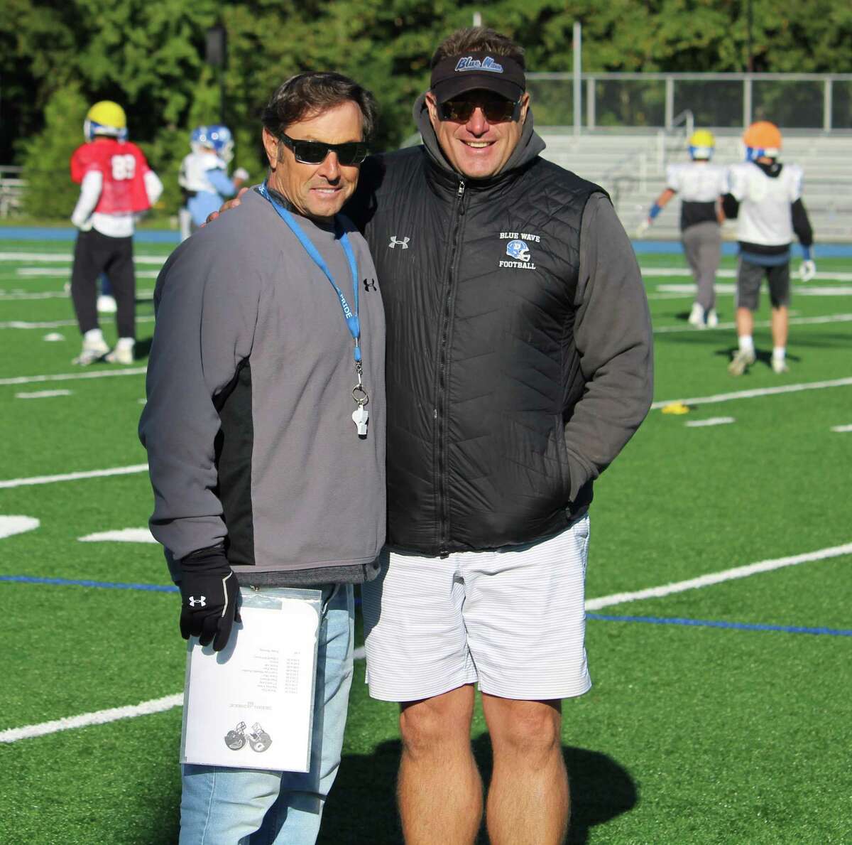 Darien coach Rob Trifone (left) and Defensive Coordinator Mike Forget pose at practice on Thursday, Oct. 18, 2018 at Darien High School in Darien, Conn.