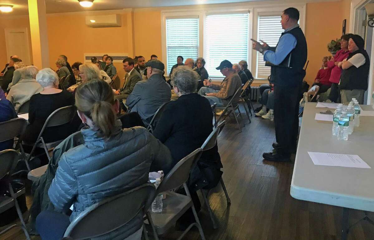 Scott Appleby (right) addresses the crowd gathered in Bridgeport, Conn., on Oct. 18, 2018, to discuss the flooding on Sept. 25.