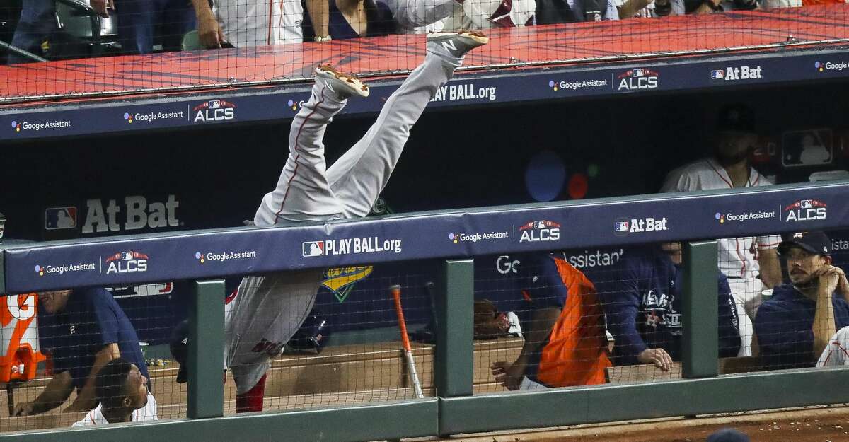 Boston Red Sox Steve Pearce (25) cannot reach a foul ball in the Astros dugout during the seventh inning of Game 4 of the American League Championship Series at Minute Maid Park on Wednesday, Oct. 17, 2018, in Houston.