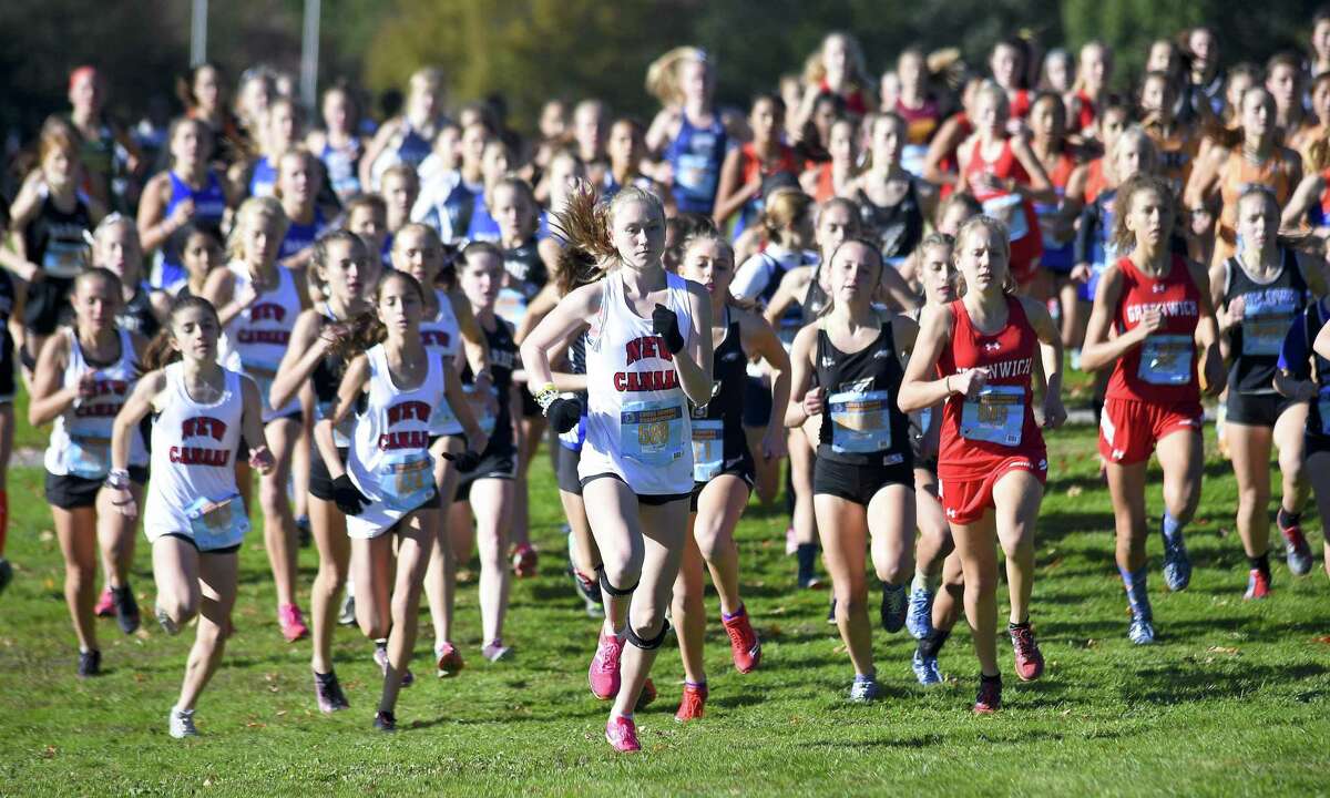 Competitors take off at the start of the FCIAC Girls Cross Country Championships on Thursday at Waveny Park in New Canaan.