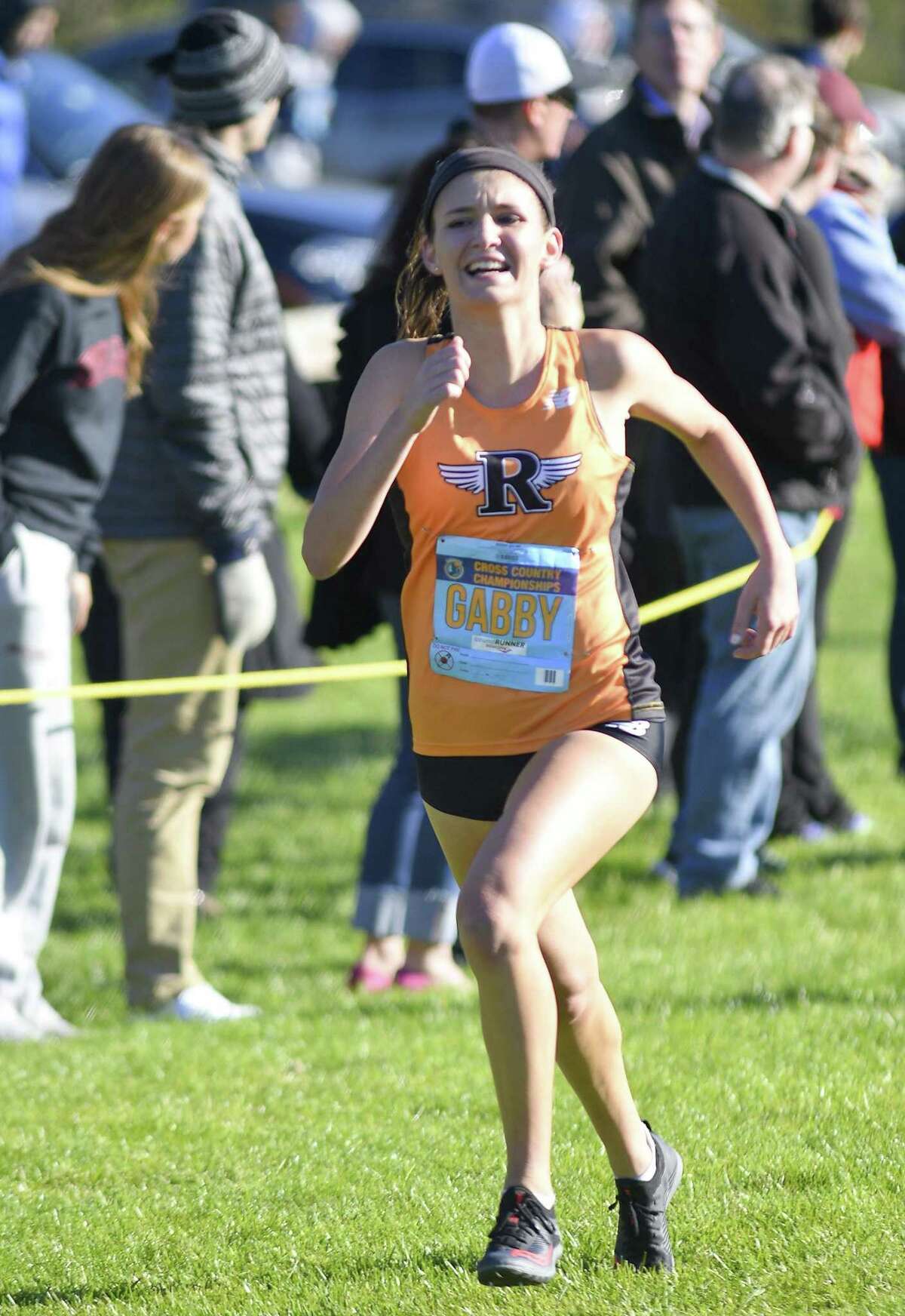 Ridgefield's Gabriella Viggiano heads to the finish line during the 2018 Cross Country Championships at Waveny Park in New Canaan, Connecticut., Thursday, Oct. 18, 2018. Viggiano 14:39.07 at the finish, edged out Danbury's Lauren Moore time of 14:39.53 to take first place, helping secure an over all third place girls team championship.