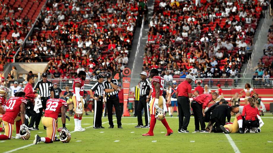 49ers' players take a knee as team personnel tend to Solomon Thomas (94) in the first quarter during the San Francisco 49ers game against the Dallas Cowboys at Levi's Stadium in Santa Clara, Calif., on Thursday, August 9, 2018. Photo: Carlos Avila Gonzalez / The Chronicle
