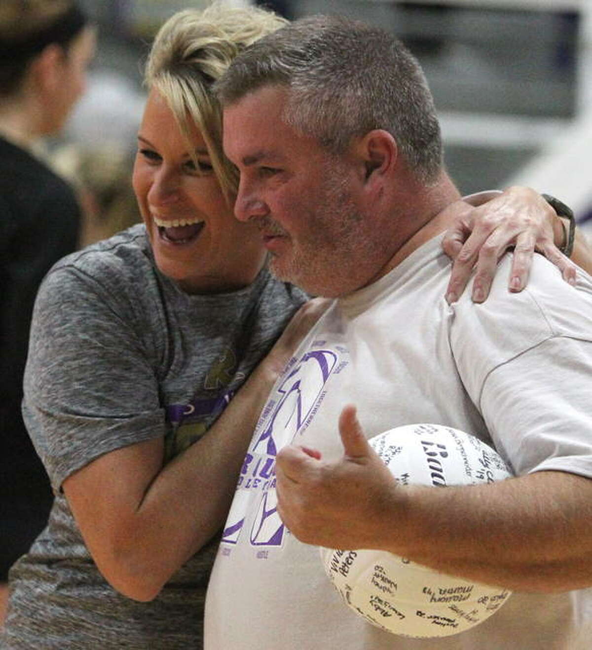 Routt coach Pat Gibson gets a hug from a former player after Thursday night’s match.