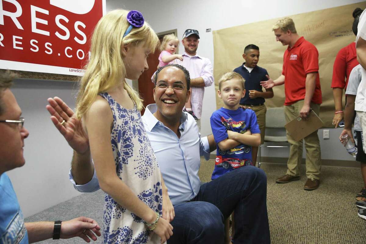 U.S. Congressman Will Hurd jokes with siblings Kyler and Bracken Purpura after he greets supporters at his northside headquarters on August 4, 2018.