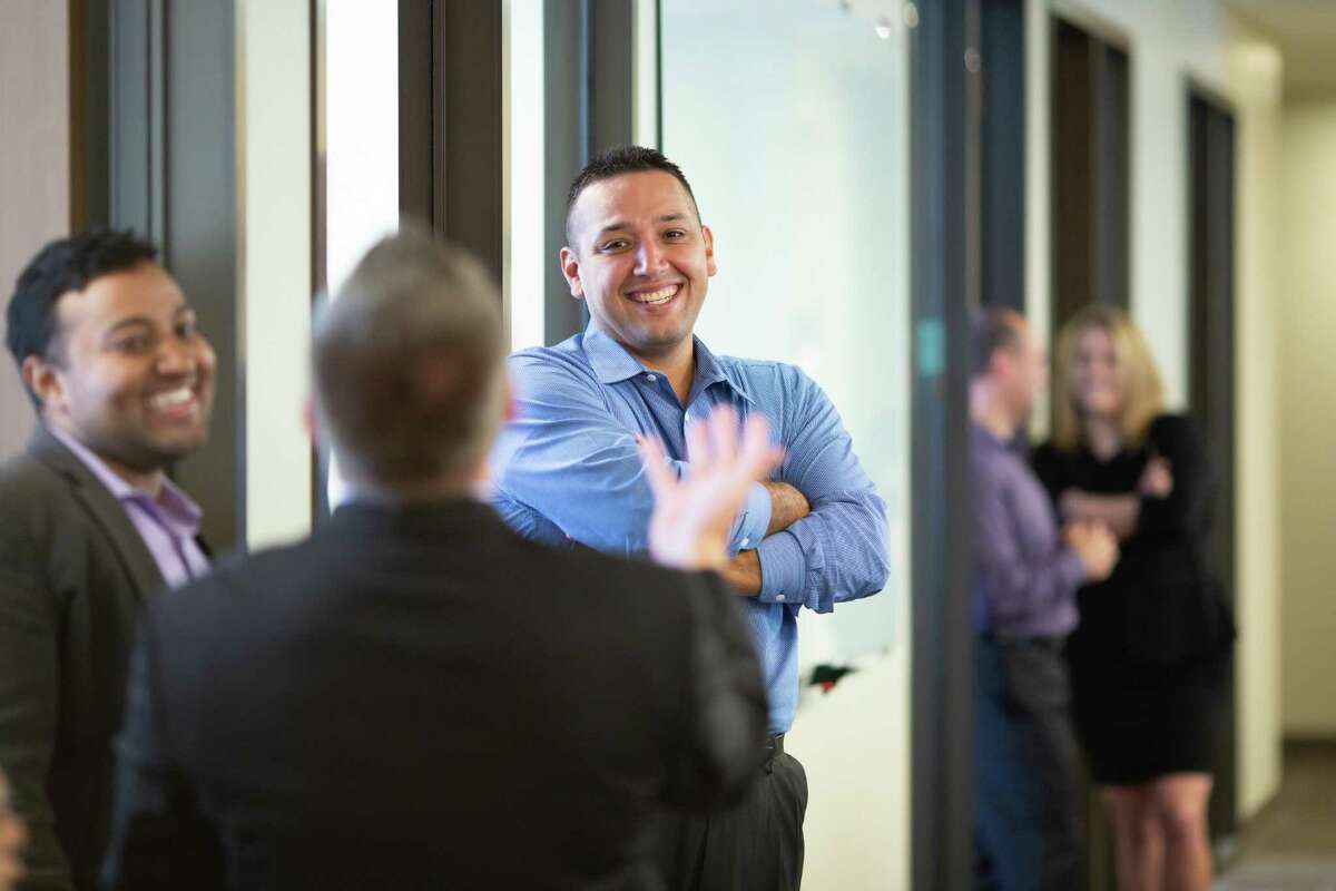 James Quintero talks with other employees before a meeting at the Texas Public Policy Foundation, Monday, Oct. 8, 2018 in Austin.