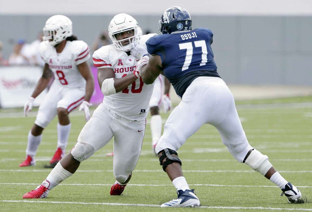 FILE - In this Sept. 1, 2018, file photo, Houston defensive tackle Ed Oliver (10) works to get around Rice offensive lineman Uzoma Osuji (77) during a NCAA college football game, in Houston. Oliver was named to The Associated Press Midseason All-America team, Tuesday, Oct. 16, 2018.(AP Photo/Michael Wyke, File)
