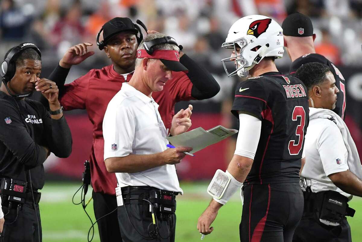 GLENDALE, AZ - OCTOBER 18: Offensive coordinator Mike McCoy (front), quarterbacks coach Byron Leftwich and head coach Steve Wilks talk with quarterback Josh Rosen #3 of the Arizona Cardinals during the second half against the Denver Broncos at State Farm Stadium on October 18, 2018 in Glendale, Arizona.