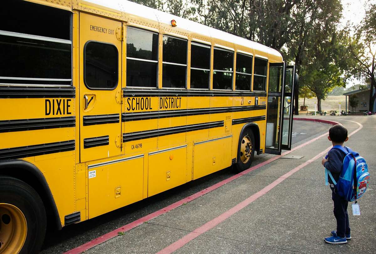 A student pauses after getting off of the school bus at Dixie Elementary School in San Rafael, California, on Thursday, Oct. 18, 2018.