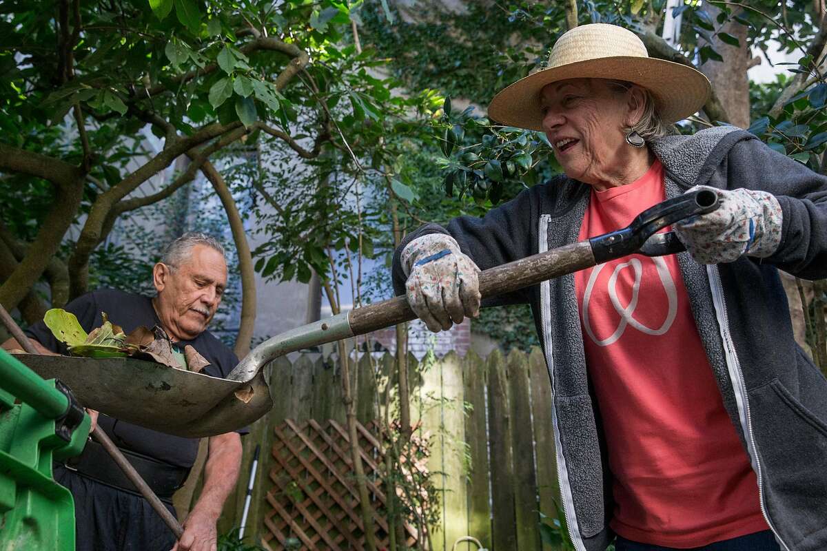 Airbnb hosts Rudolfo and Karen Cancino work on the backyard garden of their home in San Francisco, Calif. Thursday, Oct. 18, 2018.
