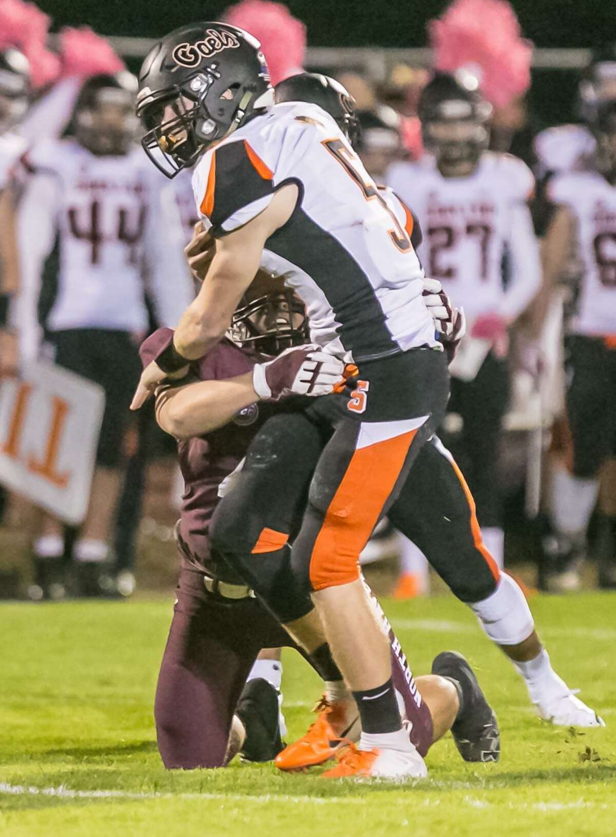Shelton’s Jack Carr tries to slip from the grip of North Haven linebacker Vin DePalma Friday in North Haven.