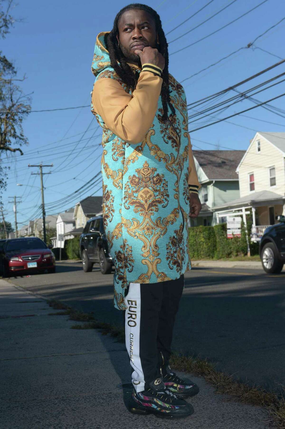 Devon Spencer, founder of EuroCurrensy clothing, outside his childhood home on Woodward Avenue Thursday, October 18, 2018, in Norwalk, Conn. Spencer was a standout on the Norwalk High School football team, was briefly homeless before starting his own clothing company, EuroCurrensy, which has been worn by rappers like Camron, Rick Ross and Cardi B.