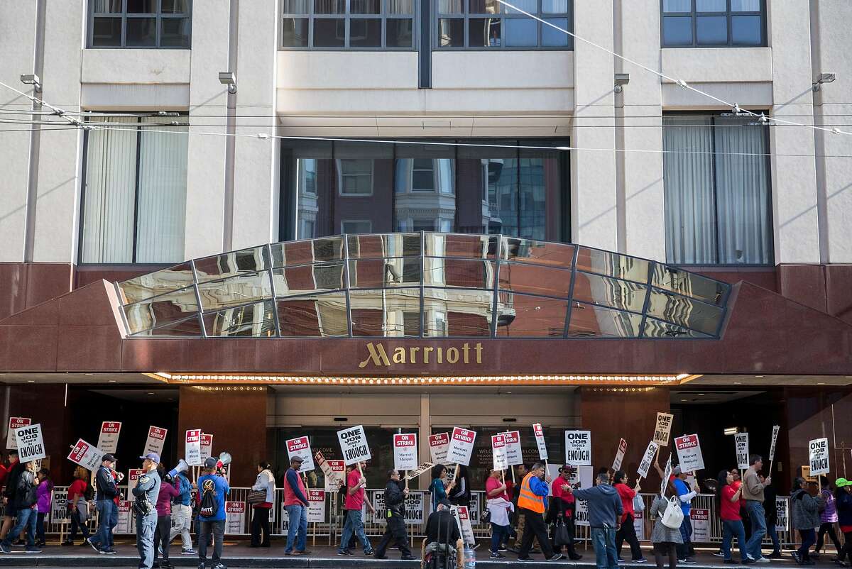 Marriott-affiliated hotel and hospitality workers on strike picket outside the Marriott Marquis hotel Saturday, Oct. 20, 2018 in San Francisco, Calif.