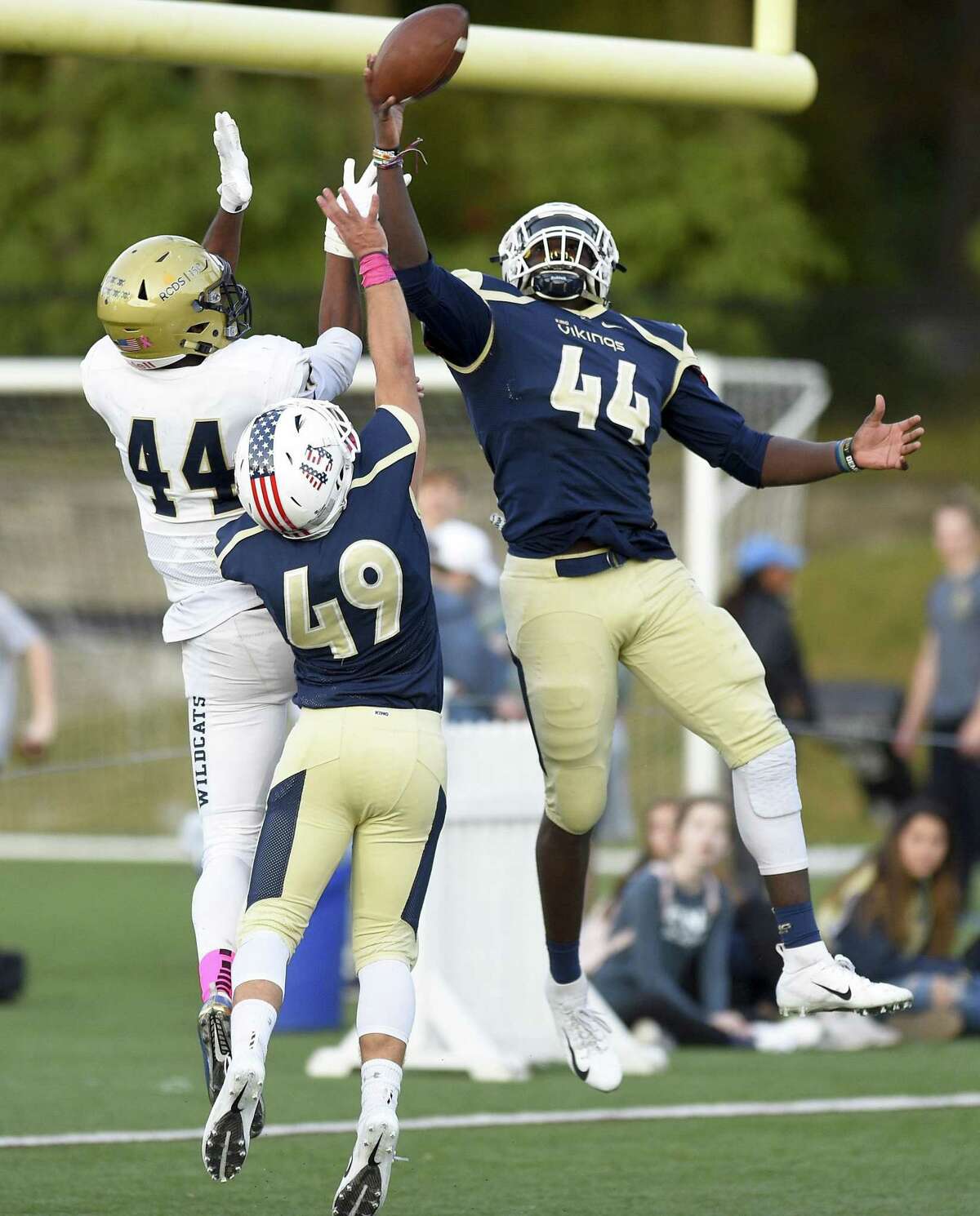 King’s Lavaughn Lewis (44) and Grady Boruchin (49) break up an end zone pass reception to Rye Country Day’s Cullen Coleman (44) during the fourth quarter of a varsity football game on Saturday in Stamford.