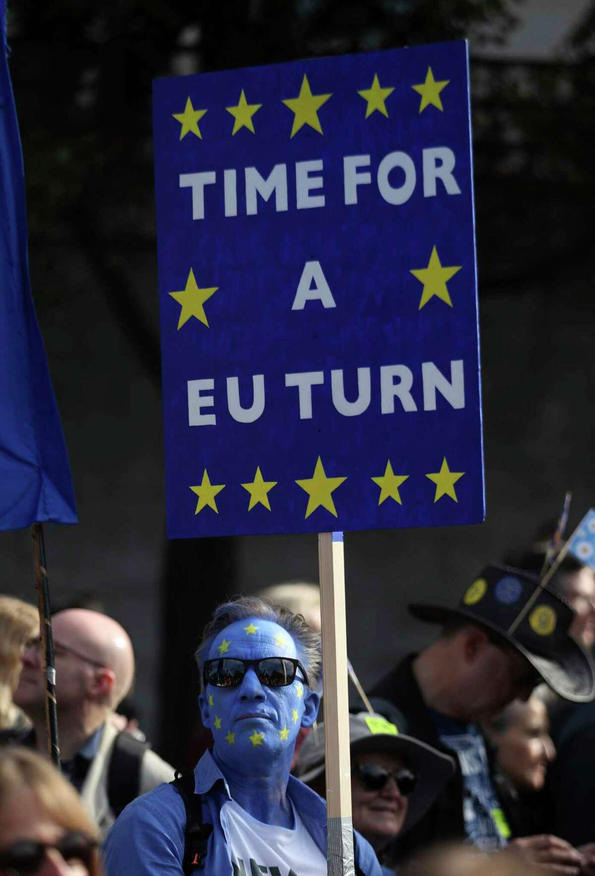 An anti-Brexit campaigner with his face painted in the colours of the European Union flag, during the People's Vote March, in London, Saturday Oct. 20, 2018. Some thousands of protesters are marching through central London, Saturday, to demand a new referendum on Britain?’s Brexit departure from the European Union. (Yui Mok/PA via AP)