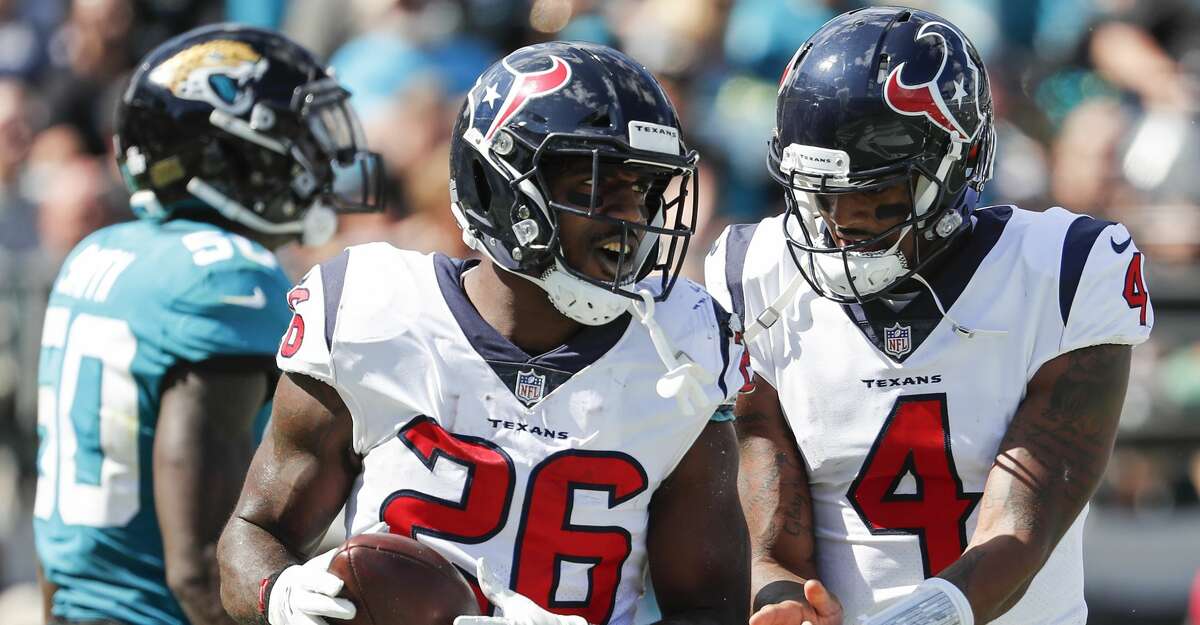 Houston Texans running back Lamar Miller (26) and quarterback Deshaun Watson (4) celebrate Miller's 5-yard touchdown run against the Jacksonville Jaguars during the second quarter of an NFL football game at TIAA Bank Field on Sunday, Oct. 21, 2018, in Jacksonville.