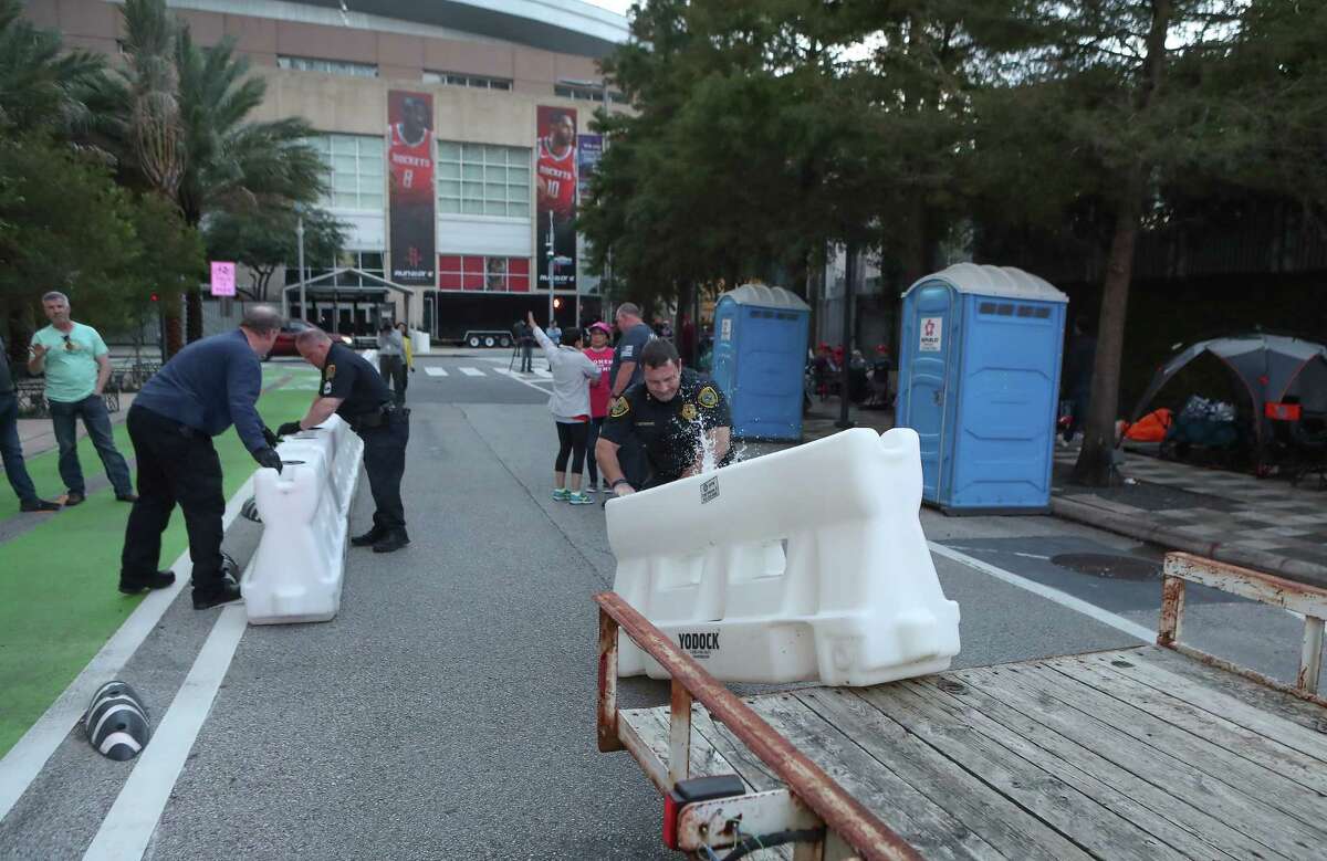 Police set up barricades before President Donald Trump's rally Monday night at Toyota Center Sunday, Oct. 21, 2018, in Houston.