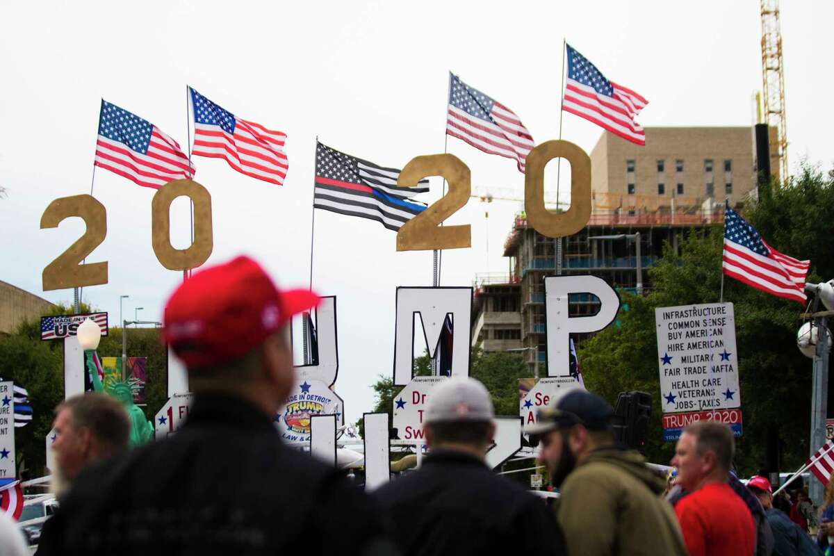 President Donald Trump supporters gather on front of the Toyota Center nine hours before the president's remarks in support of Senator Ted Cruz's candidacy, Monday, Oct. 22, 2018, in Houston.