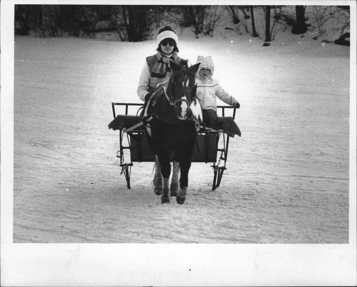 Feb. 6-7, 1978:Â Sand Lake Winter Carnival, New York - Young Jennifer Kronau of Averial Park catches a ride from Amy Irwin during winter carnival. February 6, 1978 (Times Union Archive)