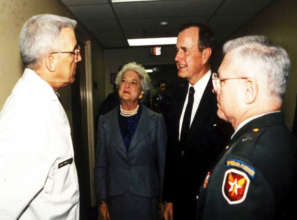 Dr. Basil Pruitt (left) is shown making rounds with First Lady Barbara Bush and President George H.W. Bush to see patients from the 1989 Panama conflict.