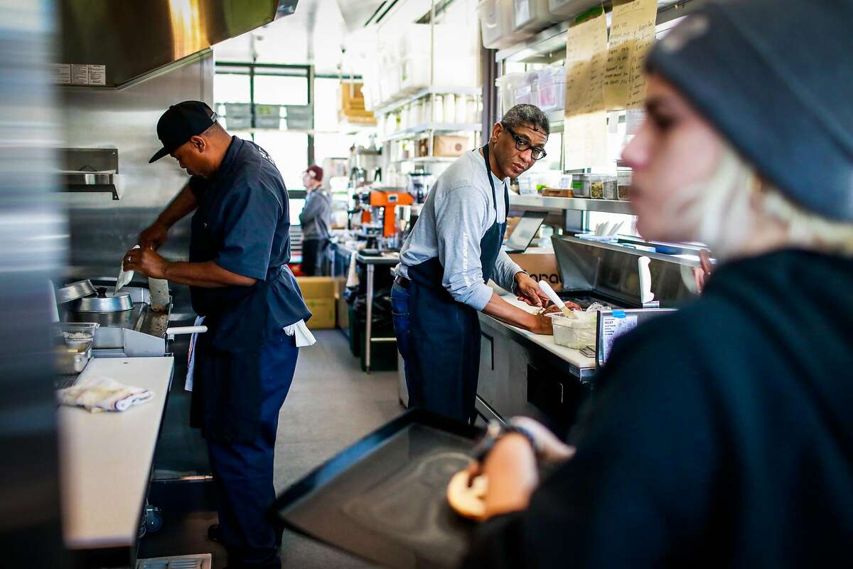(l-r) Ken Johnson, Tim Ross and Nina Solinas work to get the Bi-Rite cafe up and running just three days before the cafe opens at Civic Center in San Francisco, California, on Sunday, Oct. 21, 2018.
