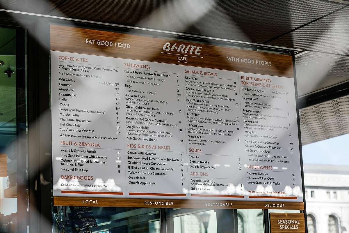 The Bi-Rite cafe menu is seen through a fence, just days before it opens in Civic Center in San Francisco, California, on Sunday, Oct. 21, 2018.