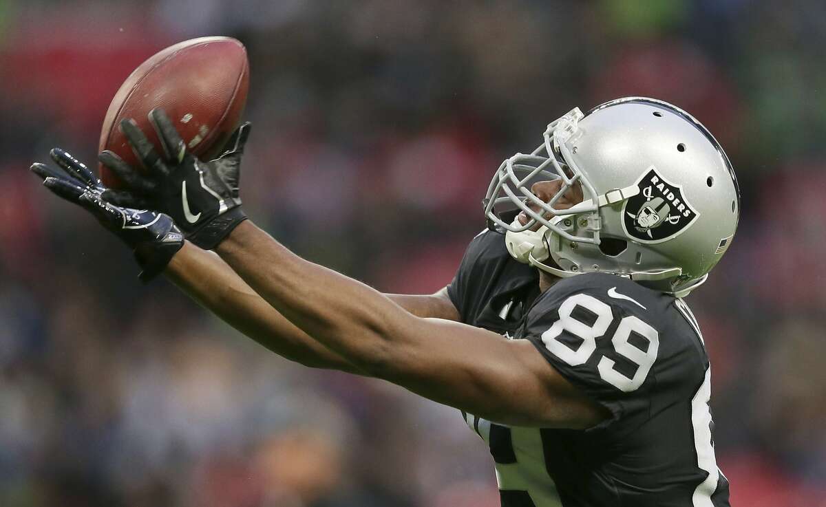 FILE - In this Oct. 14, 2018, file photo, Oakland Raiders wide receiver Amari Cooper (89) catches the ball during the warm-up before an NFL football game against Seattle Seahawks at Wembley stadium in London. The Dallas Cowboys have acquired Oakland receiver Amari Cooper for a first-round draft pick. Raiders general manager Reggie McKenzie said Monday, Oct. 22, 2018, his team will get the pick in the 2019 draft. (AP Photo/Tim Ireland, File)