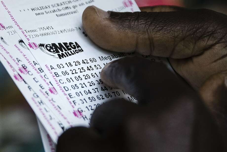 A lottery player looks over his Mega Millions lottery tickets he purchased at a news stand in Philadelphia, Monday, Oct. 22, 2018. No one won the $1 billion jackpot in Saturday night's drawing, which means the top prize for Tuesday night's Mega Millions drawing would be the largest lottery jackpot in U.S. history. Photo: Matt Rourke / Associated Press