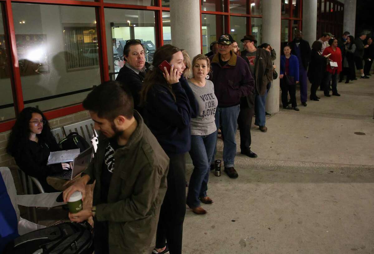 People wait in line for the early voting location at the Metropolitan Multi-Services Center on West Gray to open Monday, Oct. 22, 2018, in Houston. >>When voting, don't do this at the polls...