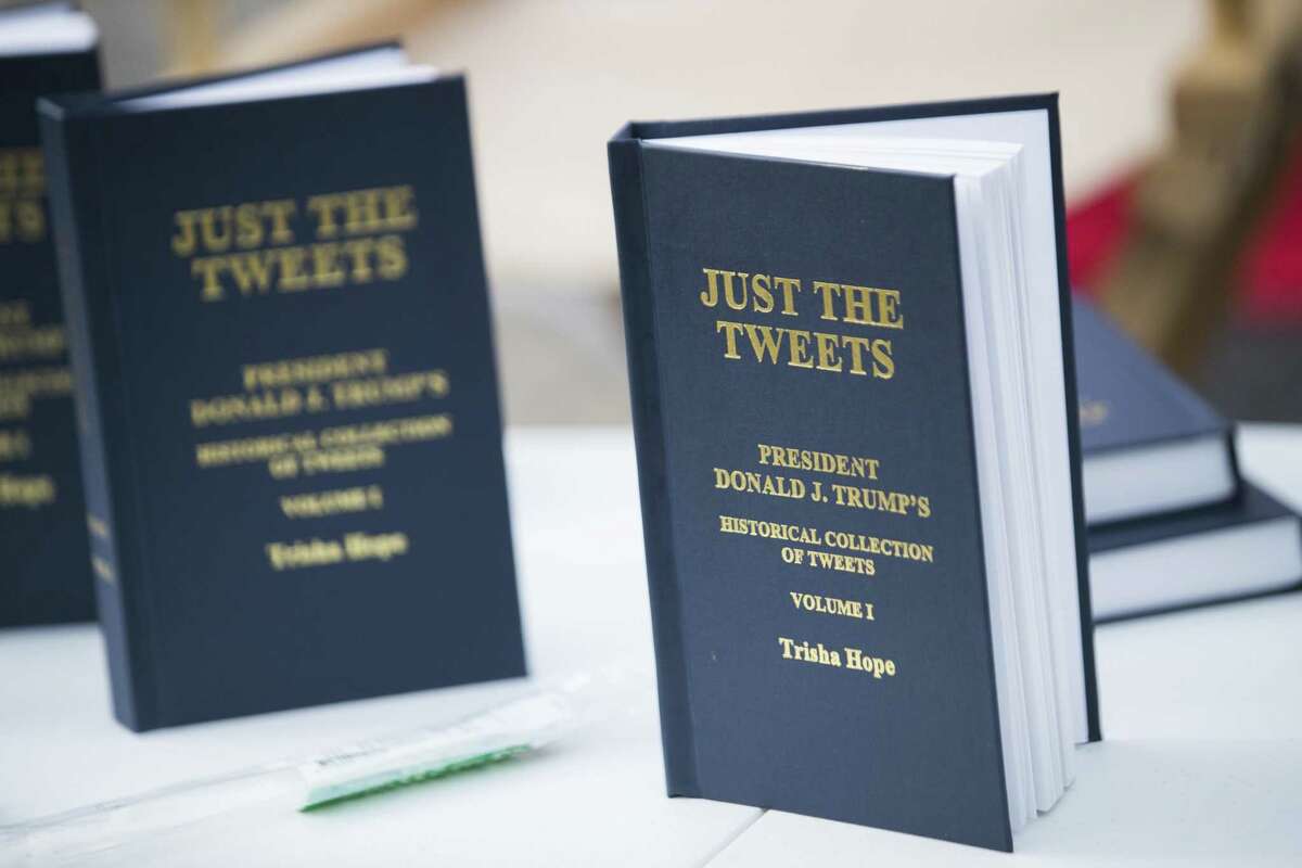 A book of President Donald Trump's tweets in front of the Toyota Center during a rally, Monday, Oct. 22, 2018, in Houston.