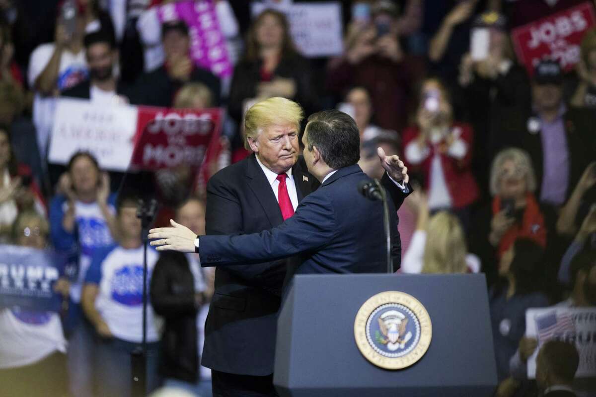 President Donald Trump embraces Senator Ted Cruz as he arrives to the podium during the MAGA Rally at the Toyota Center, Monday, Oct. 22, 2018, in Houston.