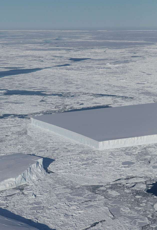 "A tabular iceberg can be seen on the right, floating among sea ice just off of the Larsen C ice shelf. The iceberg's sharp angles and flat surface indicate that it probably recently calved (split off) from the ice shelf," NASA reports. Photo: NASA