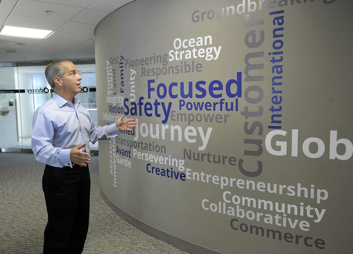Cosmo Alberico, COO and CFO of Odyssey Logistics & Technology in Danbury, talks about a wall filled with inspirational words in a hallway of Odyssey's office space at the Matrix Conference Center in Danbury.