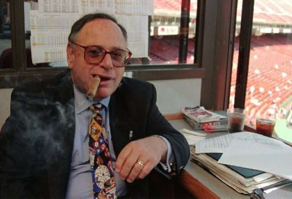 San Francisco Giants radio play-by-play broadcaster Hank Greenwald enjoys one of his always present Dunhill cigars in the broadcast booth atop 3Com Park after announcing his retirement in San Francisco, Tuesday, Aug. 27, 1996, prior to the San Francisco Giants game against Philadelphia. Greenwald, who has worked 16 seasons for the Giants, will retire at the end of the season. (AP Photo/Eric Risberg) ALSO RAN 4/21/99, MN
