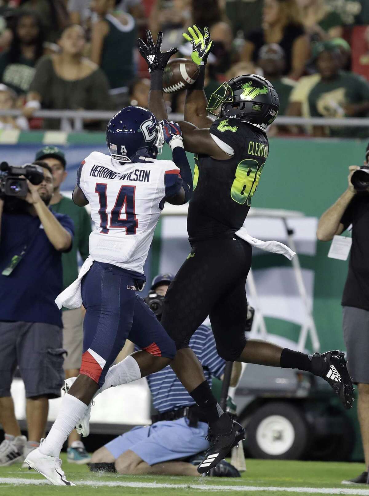 UConn defensive back Tahj Herring-Wilson breaks up a pass intended for South Florida wide receiver Stanley Clerveaux on Saturday.