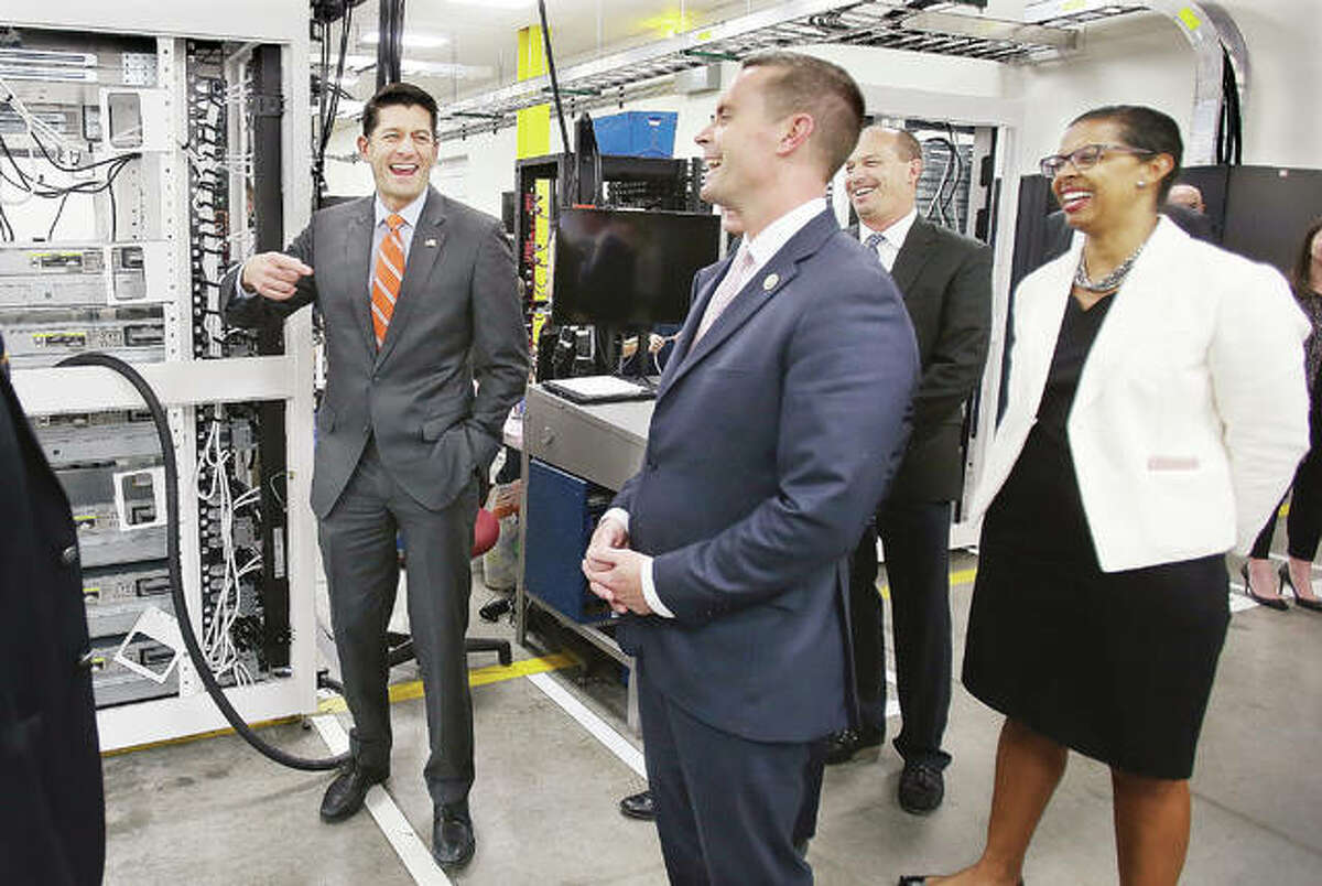 U.S. House Speaker Paul Ryan, R-Wis., left, shares a laugh with U.S. Rep. Rodney Davis, R-Taylorville, center, and others Tuesday during a brief tour of where mainframe stands are being assembled in the World Wide Technology warehouse on Lakeview Corporate Drive in Edwardsville. Ryan was in town for a fundraiser earlier in the day and made the visit to the company’s facility with Davis.