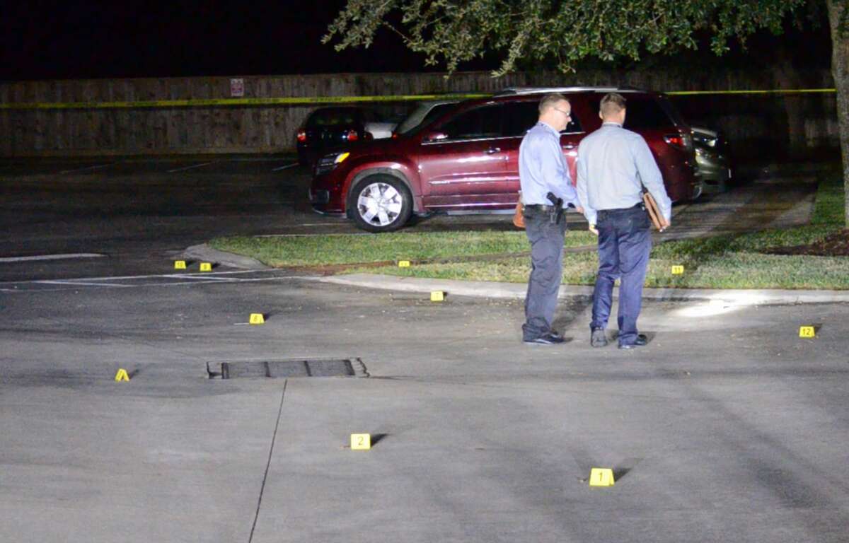 Houston police officers and homicide detectives investigate the shooting death of a teenager in southwest Houston on Monday, Oct. 23, 2018.