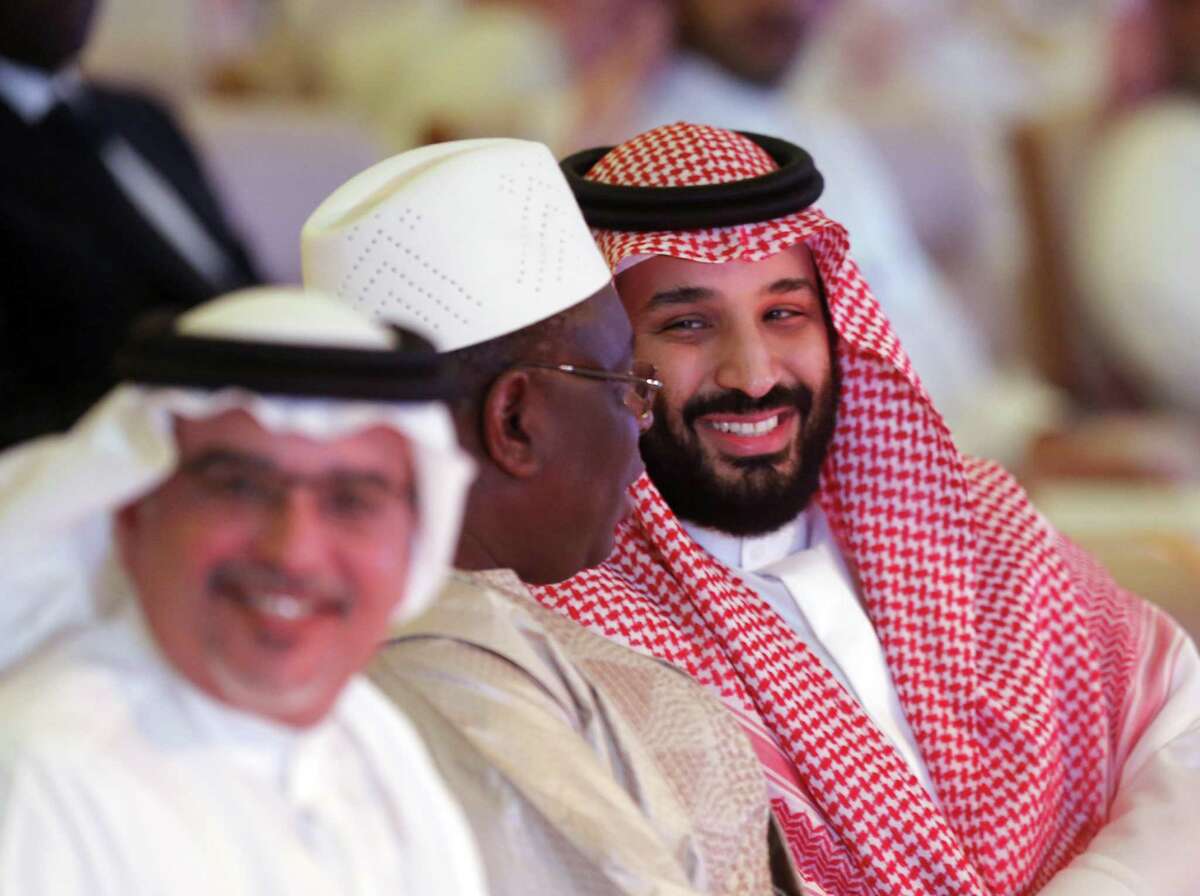 Saudi Crown Prince, Mohammed bin Salman, right, smiles as he talks to Senegali President Macky Sall, center, during the Future Investment Initiative conference, in Riyadh, Saudi Arabia, Wednesday, Oct. 24, 2018. Many participants withdrew following the killing earlier this month of Washington Post columnist Jamal Khashoggi at the Saudi Consulate in Istanbul.