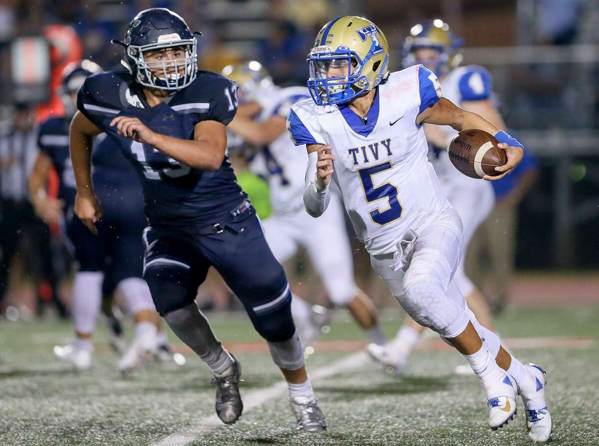 Kerrville Tivy's Karson Valverde (right) tries to run past Boerne Champion's Lake Shara during the second half of their District 14-5A-II high school football game at Boerne Stadium on Friday, Sept. 21, 2018.