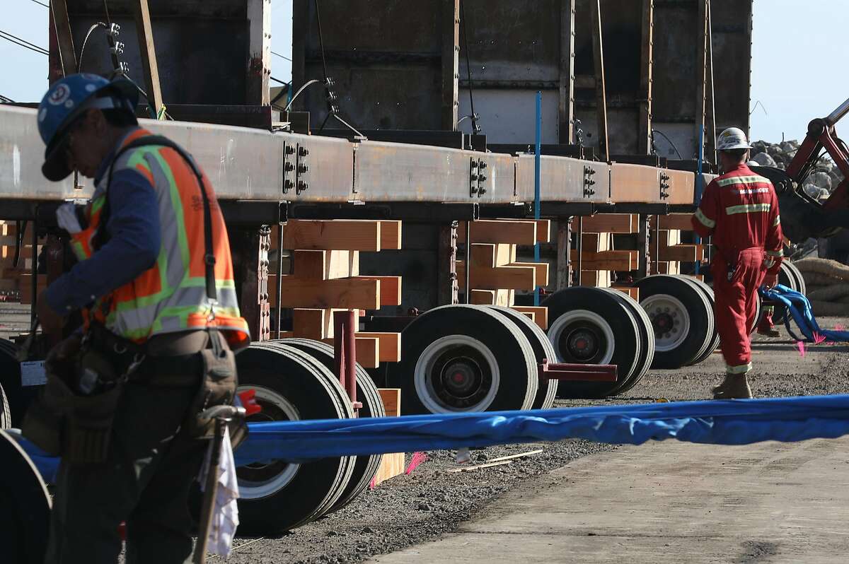 A 153 ton building frame is placed on stands before carriers are removed at a historic shipyard property in Wednesday, Oct. 24, 2018 in San Francisco, Calif.