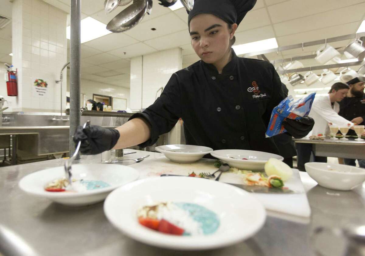 Madison High School culinary arts studentSara Fernandez puts the finishing touches on a dish Wednesday, Oct. 24, 2018 at Madison High School during a cooking competition held to promote Amazon's recent 100 grants to fund offering school breakfast in classrooms.