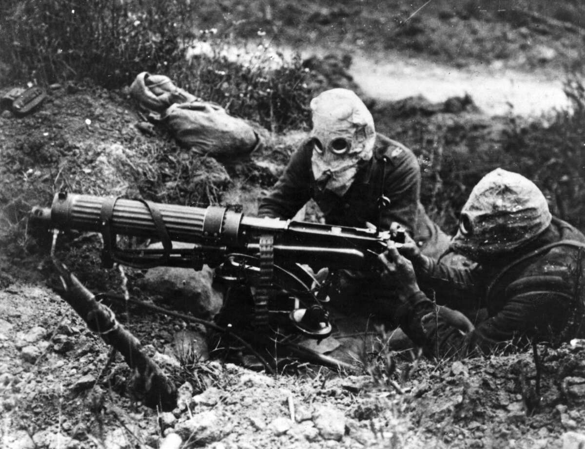 Gas-masked men of the British Machine Gun Corps with a Vickers machine gun during the first battle of the Somme. (Photo by General Photographic Agency/Getty Images)