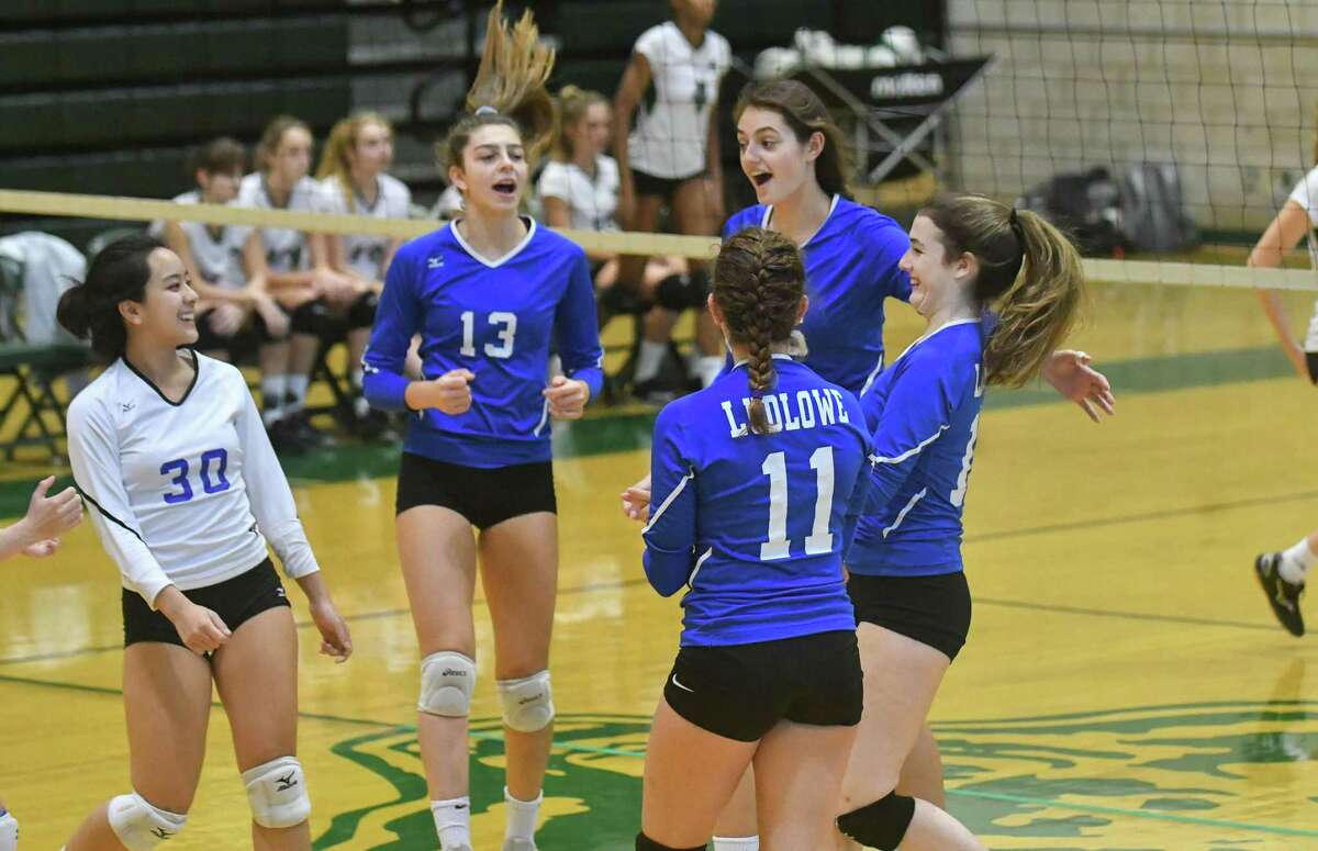 Members of the Fairfield Ludlowe volleyball team celebrate a Game 1 victory during a match against Norwalk on Wednesday.