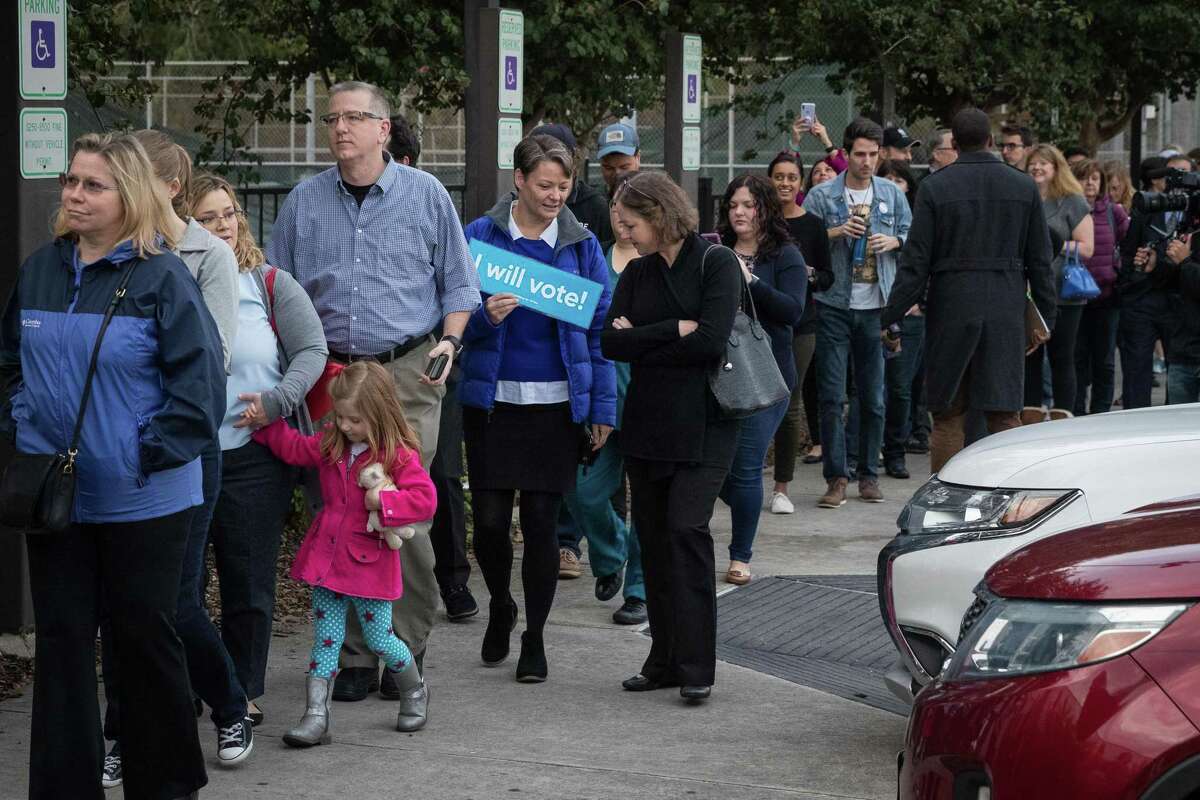 People wait in line to vote at a polling place on the first day of early voting on October 22, 2018 in Houston, Texas. Democratic Senate candidate Rep. Beto O'Rourke is running against Republican Sen. Ted Cruz in the midterm elections.