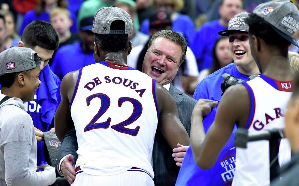 Silvio De Sousa (22) receives a big hug from Kansas head coach Bill Self after an 81-70 win against West Virginia in the Big 12 Tournament championship game.The sophomore forward De Sousa will be held out of competition while an eligibility review is conducted, Jayhawks coach Bill Self announced Wednesday.