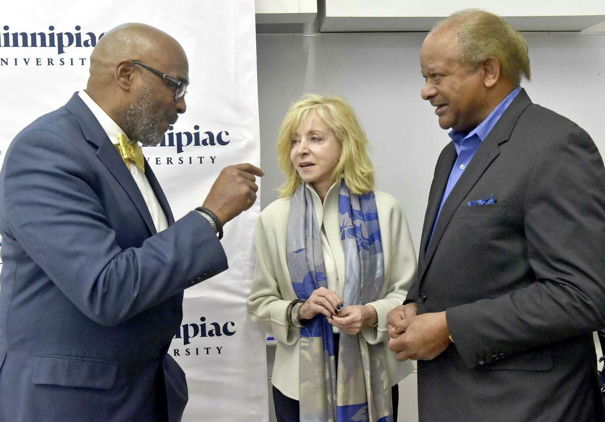 Hamden, Connecticut - Wednesday, October 24, 2018: Fred McKinney, the Carlton Highsmith Chair of Innovation and Entrepreneurship and the Director of the People's United Center for Innovation and Entrepreneurship at Quinnipiac University, left, Quinnipiac University President Judy Olian, center, and Carlton Highsmith, vice chairman of the Quinnipiac University Board of Trustees who established the Carlton Highsmith Chair of Innovation and Entrepreneurship in 2012 with a $1million gift, right, at the Quinnipiac University's School of Business reception Wednesday evening marking the re-opening of the People's United Center for Innovation and Entrepreneurship at Quinnipiac University in Hamden.